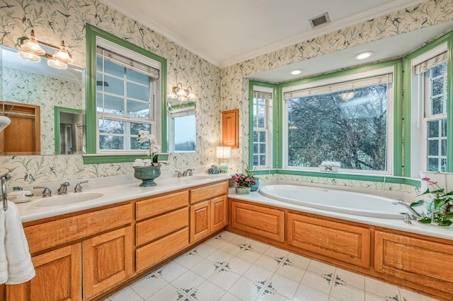 bathroom with tile patterned floors, a washtub, crown molding, and vanity