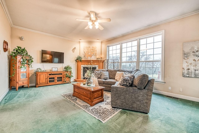 living room featuring carpet floors, ceiling fan, and crown molding