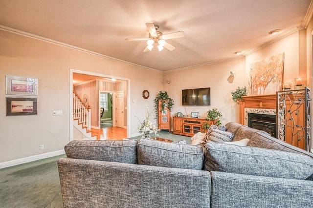 living room with carpet flooring, ceiling fan, and crown molding