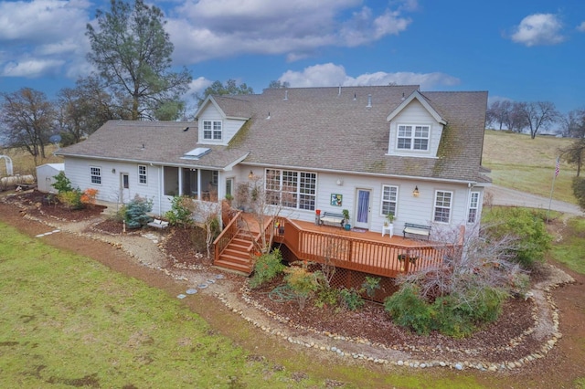 rear view of house with a yard and a deck