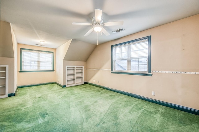 bonus room with light colored carpet, vaulted ceiling, plenty of natural light, and ceiling fan