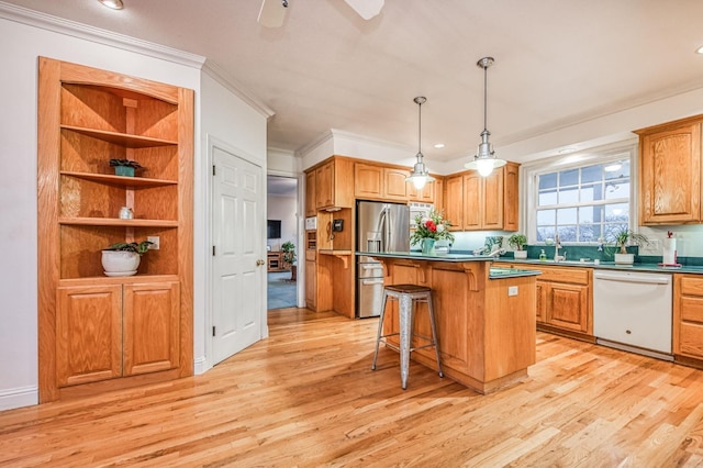 kitchen with stainless steel fridge, white dishwasher, a kitchen bar, a kitchen island, and light wood-type flooring