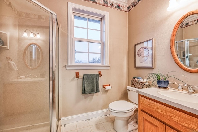 bathroom featuring tile patterned floors, vanity, toilet, and walk in shower