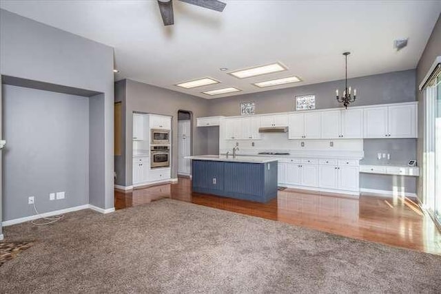 kitchen with white cabinetry, pendant lighting, an island with sink, and appliances with stainless steel finishes