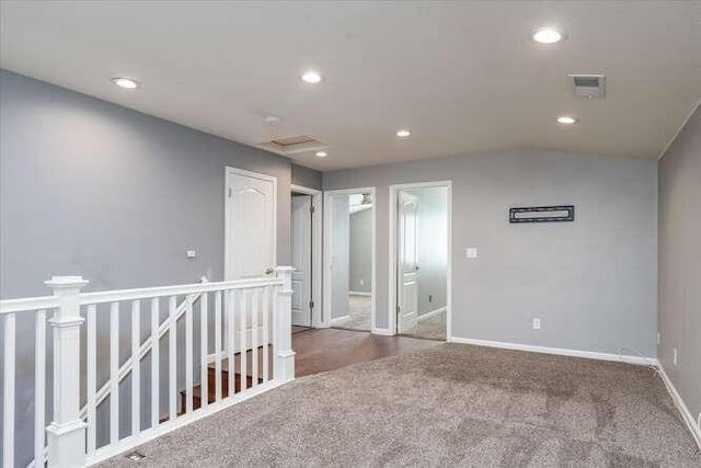 empty room with dark colored carpet