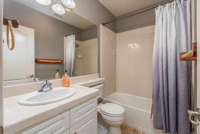 full bathroom with vanity, shower / bath combination with curtain, and toilet