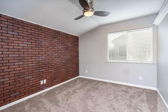 carpeted spare room featuring ceiling fan, brick wall, and vaulted ceiling