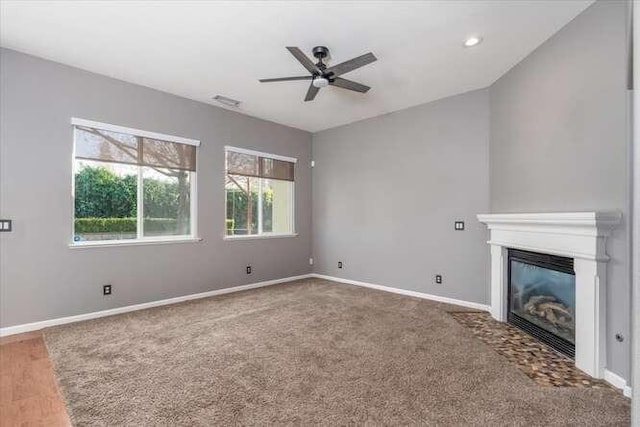 unfurnished living room featuring wood-type flooring and ceiling fan