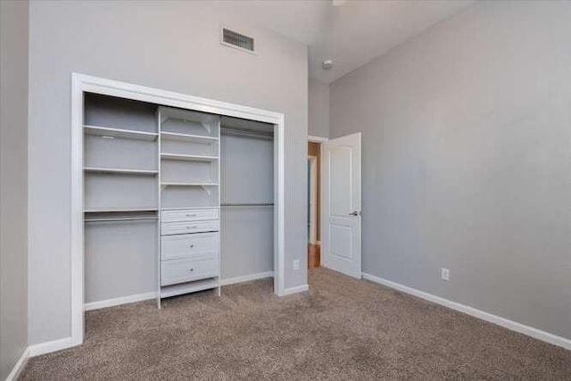 unfurnished bedroom with carpet floors and a closet