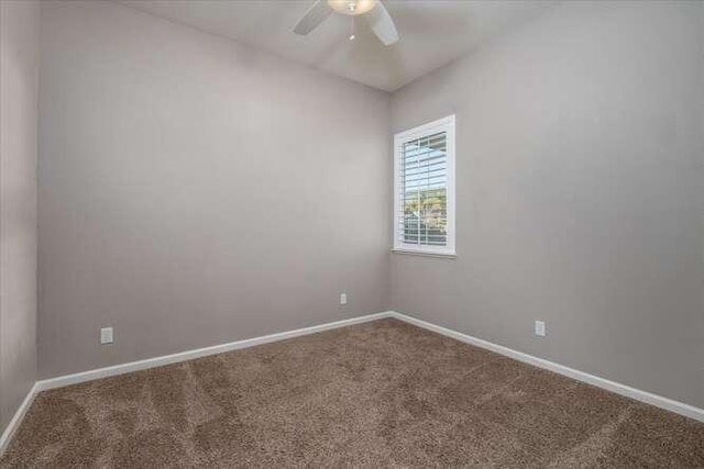 spare room with ceiling fan and carpet