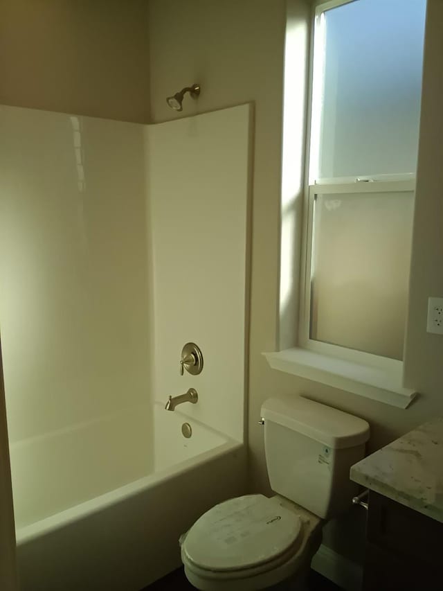 bathroom with shower / bathing tub combination and toilet
