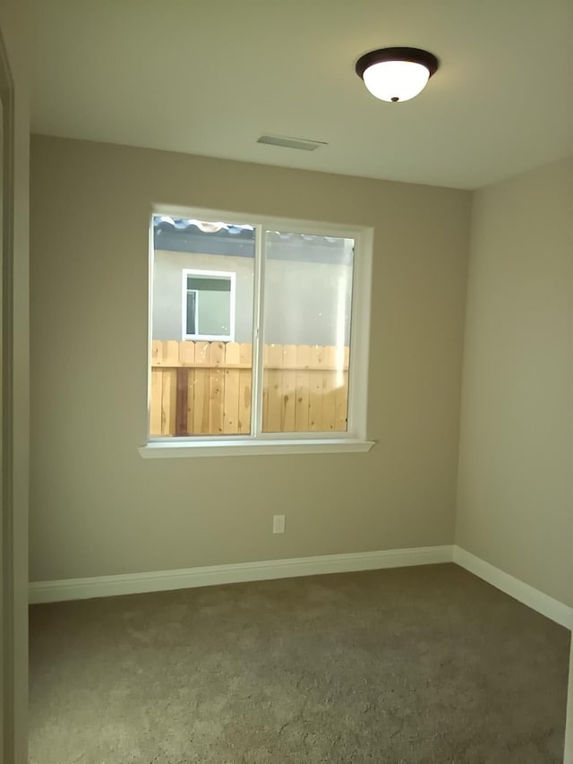 spare room with visible vents and baseboards