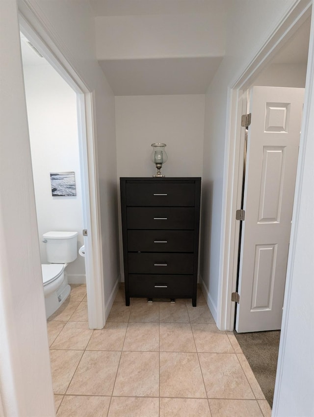 bathroom with tile patterned flooring and toilet