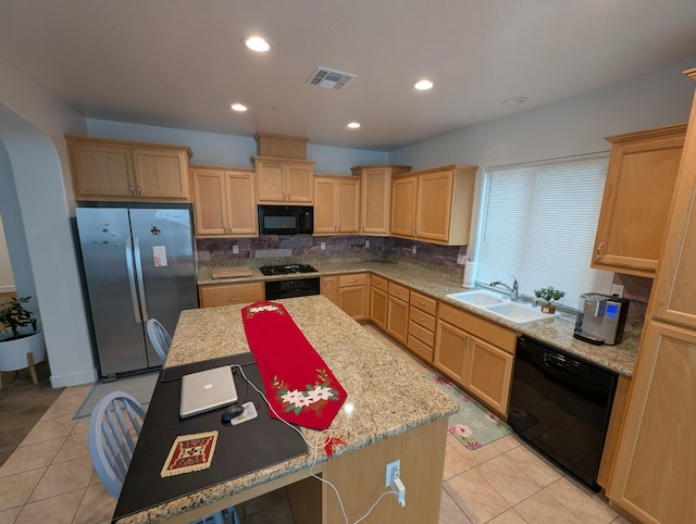 kitchen featuring decorative backsplash, sink, a center island, and black appliances