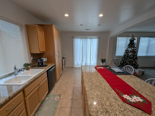 kitchen with dishwasher, sink, light tile patterned floors, and light stone countertops