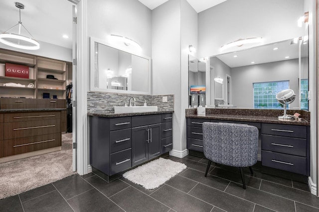 bathroom with vanity, tile patterned flooring, and decorative backsplash