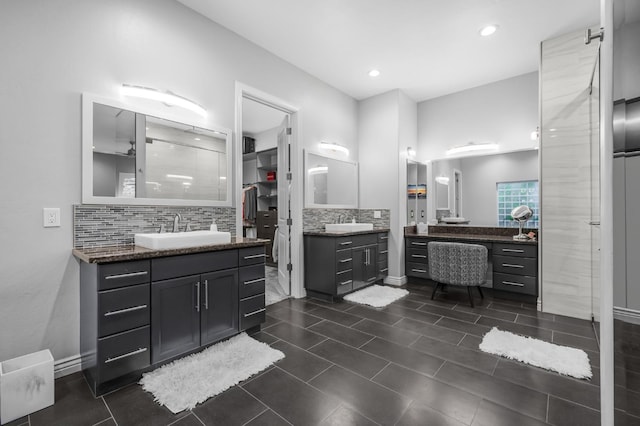 bathroom with tasteful backsplash and vanity