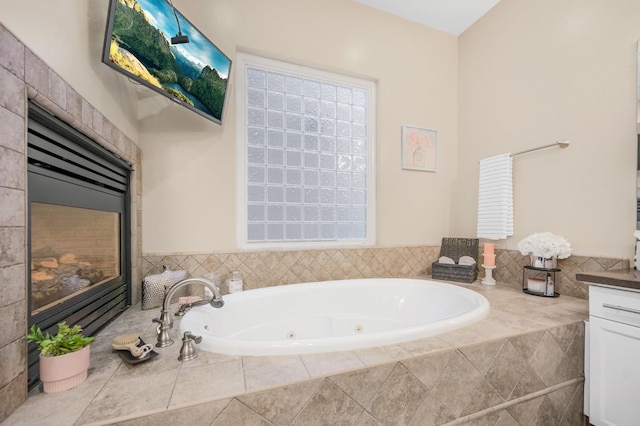 bathroom with vanity and tiled bath