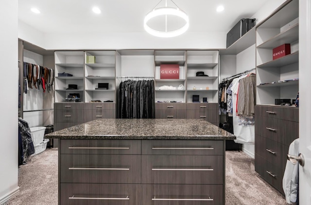 walk in closet featuring light colored carpet