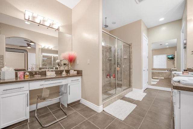 bathroom with a shower with door, vanity, tile patterned floors, and ceiling fan