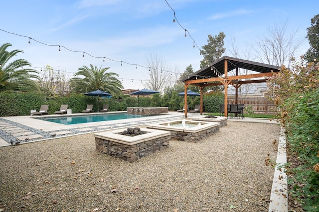 view of pool featuring a gazebo, an outdoor fire pit, and a patio