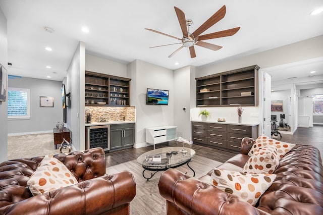 living room featuring wine cooler, ceiling fan, and dark hardwood / wood-style floors