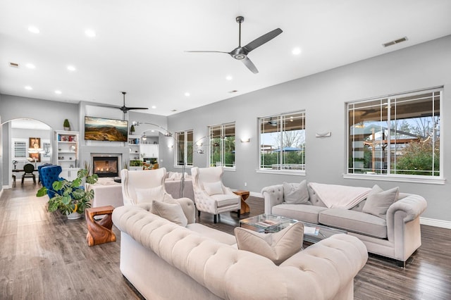 living room featuring ceiling fan and dark hardwood / wood-style floors