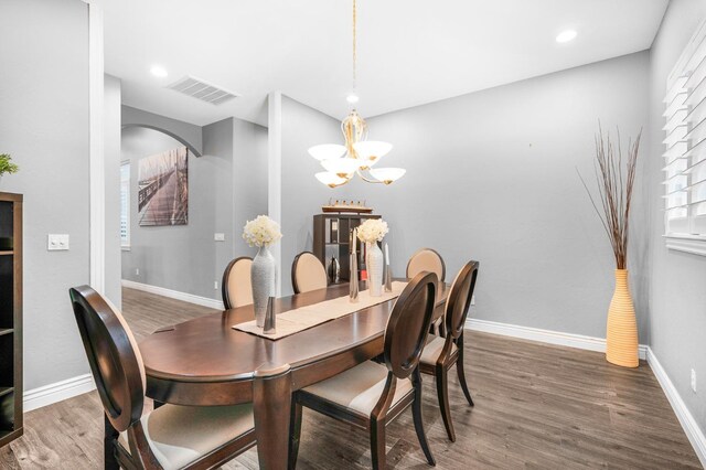 dining room featuring dark hardwood / wood-style flooring and a chandelier