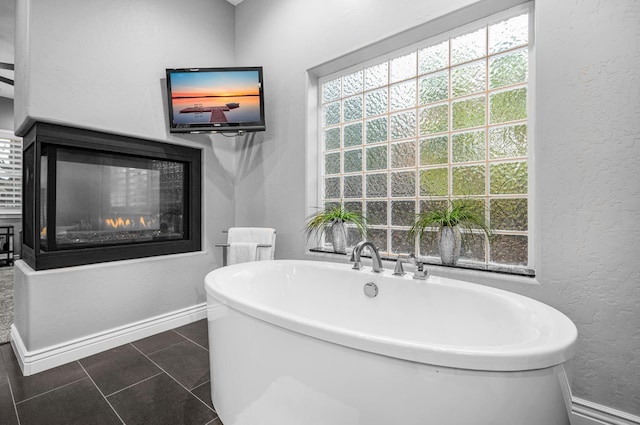 bathroom with tile patterned floors and a bathtub