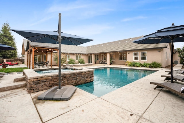 view of swimming pool with a patio and an in ground hot tub