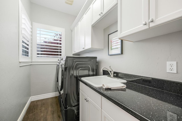 clothes washing area with cabinets, washer / dryer, sink, and dark hardwood / wood-style flooring