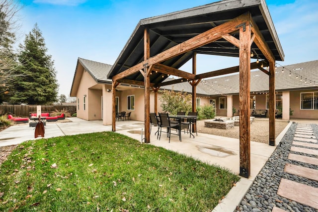 exterior space with a yard, a gazebo, an outdoor living space with a fire pit, and a patio