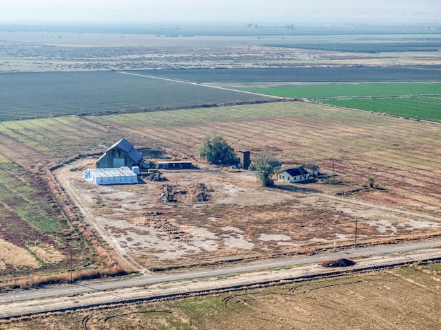 birds eye view of property with a rural view