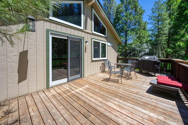 wooden terrace featuring a grill