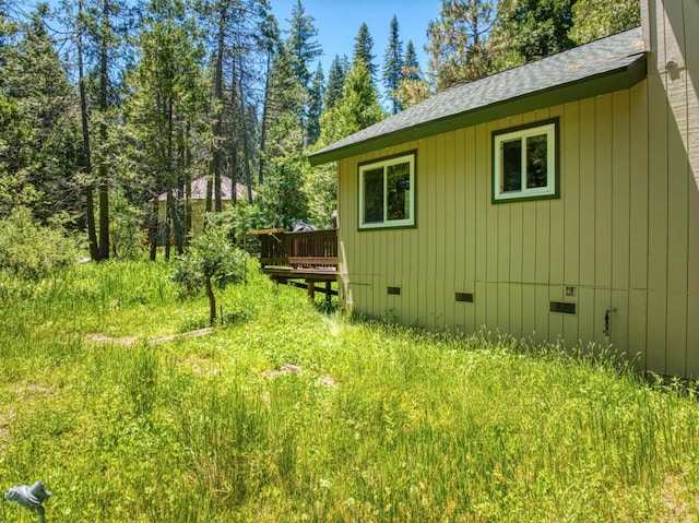 view of side of home featuring a wooden deck