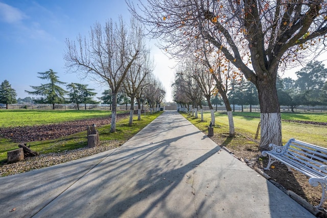 surrounding community featuring a yard and a rural view