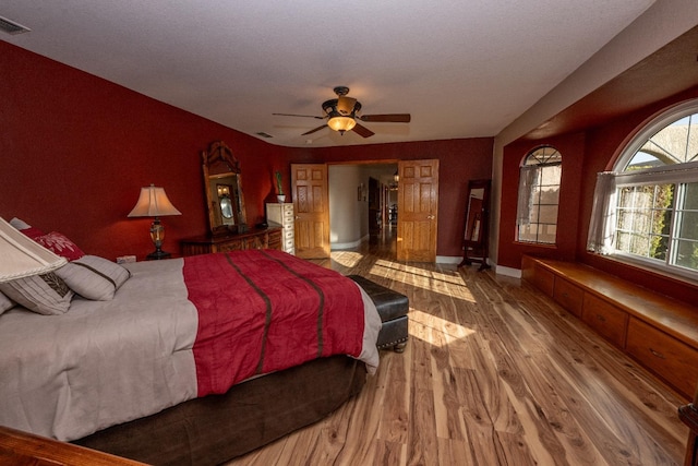 bedroom featuring ceiling fan and hardwood / wood-style flooring