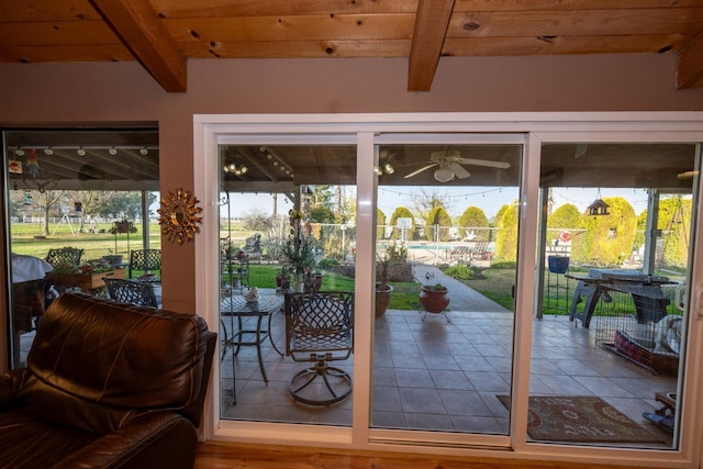 doorway with ceiling fan, beamed ceiling, wooden ceiling, and hardwood / wood-style flooring