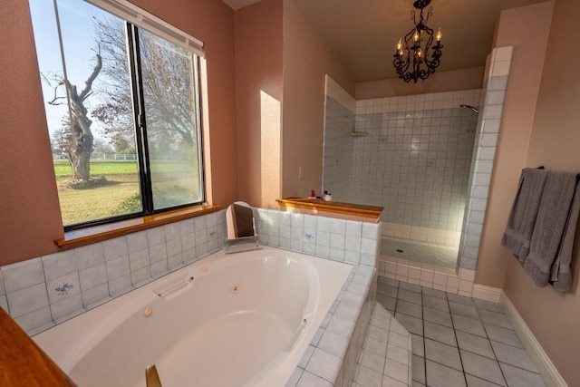 bathroom featuring separate shower and tub, a wealth of natural light, tile patterned floors, and an inviting chandelier