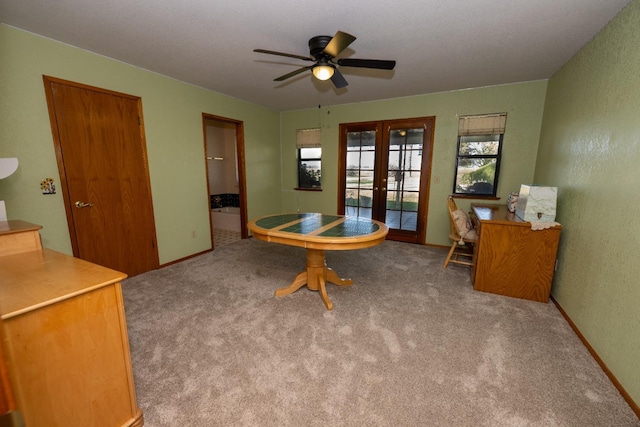 interior space featuring carpet, french doors, and ceiling fan