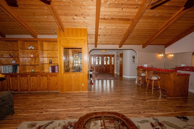 living room with wood-type flooring, lofted ceiling with beams, and wood ceiling