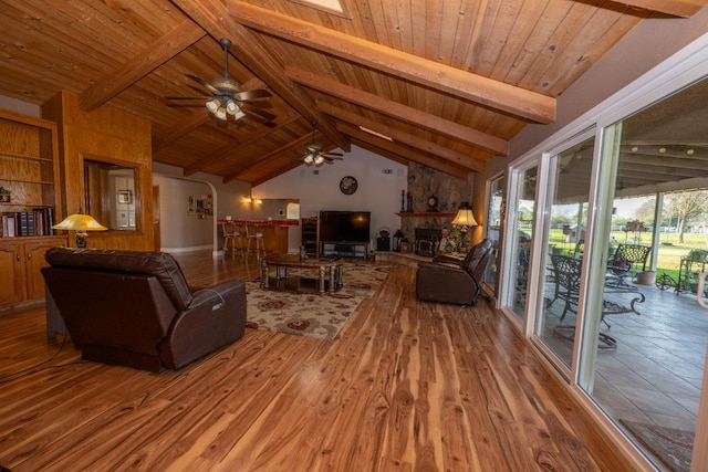 living room with hardwood / wood-style floors, vaulted ceiling with beams, ceiling fan, and wood ceiling