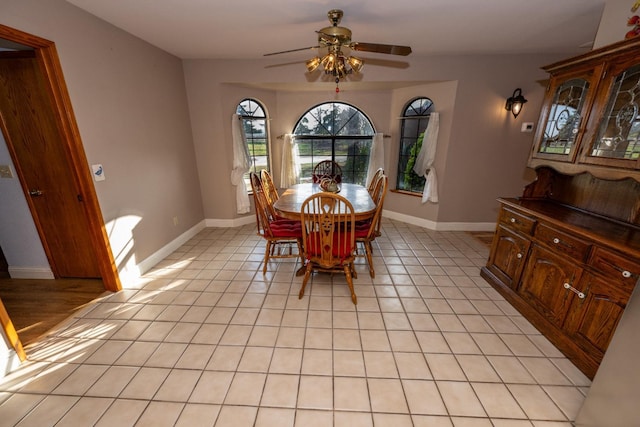 tiled dining area featuring ceiling fan