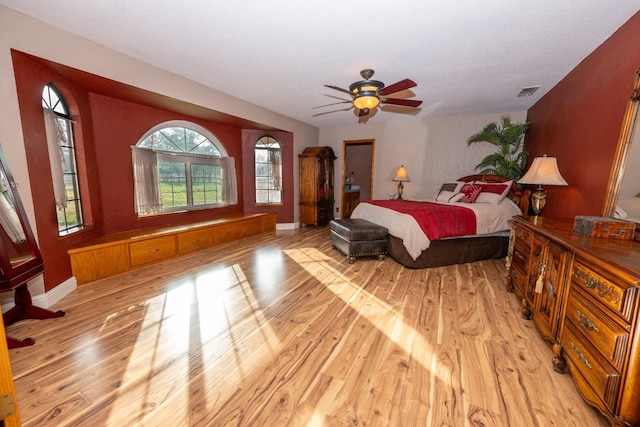 bedroom with light hardwood / wood-style floors and ceiling fan