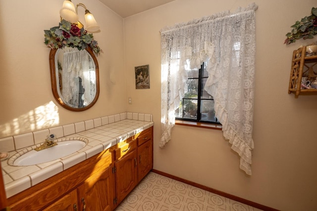 8510 E Nees Ave, Clovis, CA 93619 - bathroom featuring vanity, baseboards, and tile patterned floors