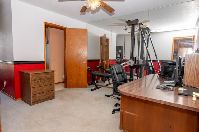 office featuring a textured ceiling, light colored carpet, and ceiling fan