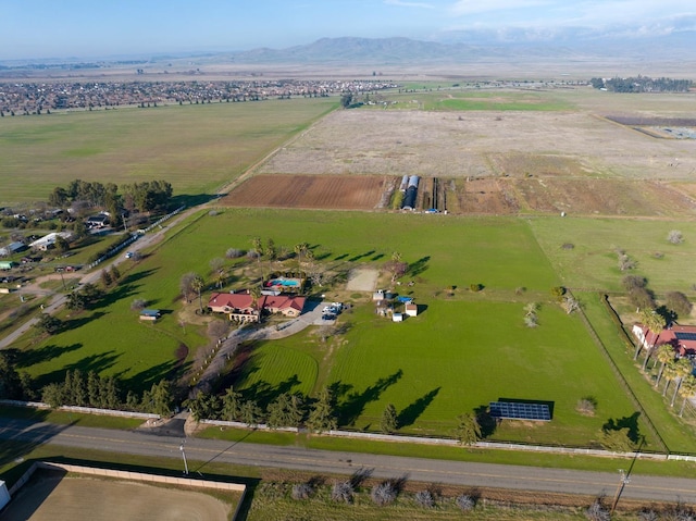 birds eye view of property with a mountain view and a rural view