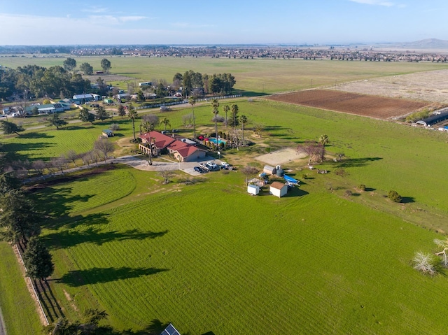 birds eye view of property with a rural view