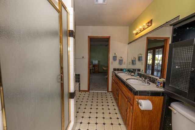 8510 E Nees Ave, Clovis, CA 93619 - bathroom featuring toilet, a shower stall, double vanity, and tile patterned floors