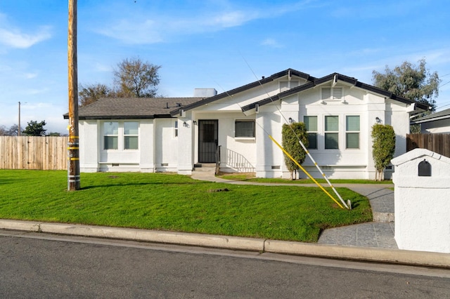 ranch-style house featuring a front lawn